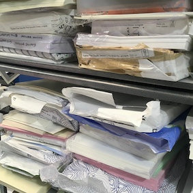 packets of premium paper stack on a shelf